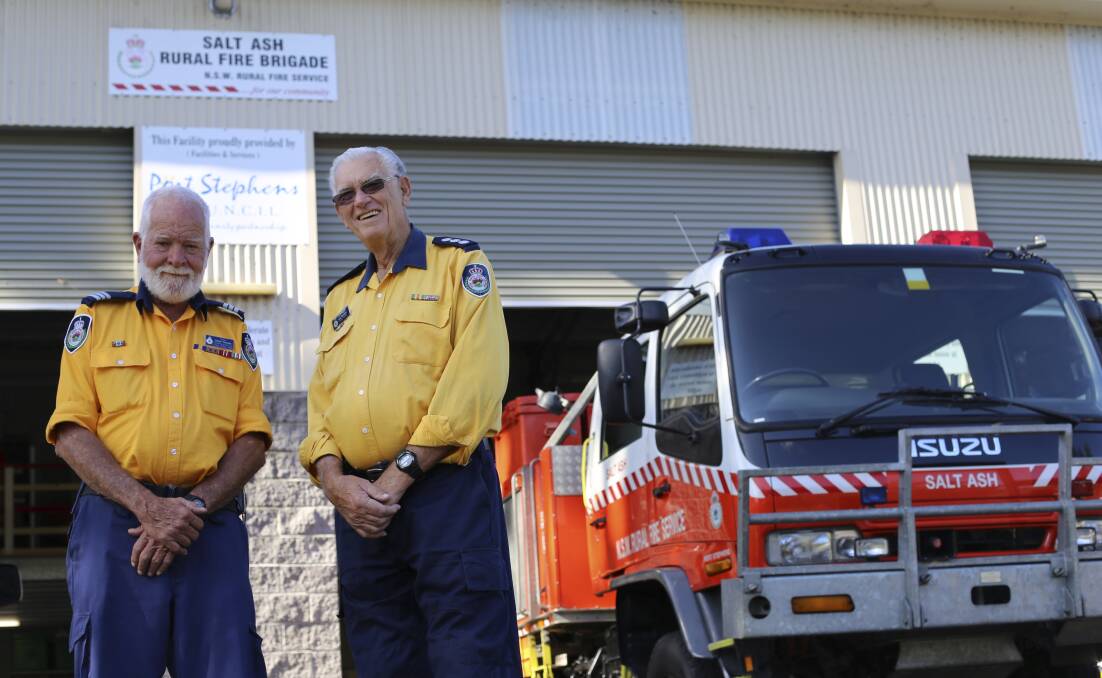 HAPPY: Williamtown-Salt Ash Rural Fire Service captain David Thomas with lower Hunter group captain Les Bowden. The RFS brigade's grant bid for a GPS for Mr Bowden was successful. Picture: Ellie-Marie Watts 