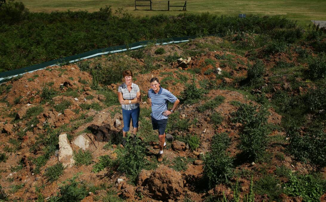 Costly: Port Stephens Councillor Geoff Dingle and Salt Ash Pony Club president Lisa Gregory on 2000 tonnes of soil dumped at Alexander Park on the direction of Port Stephens mayor Bruce MacKenzie. It must be removed. 