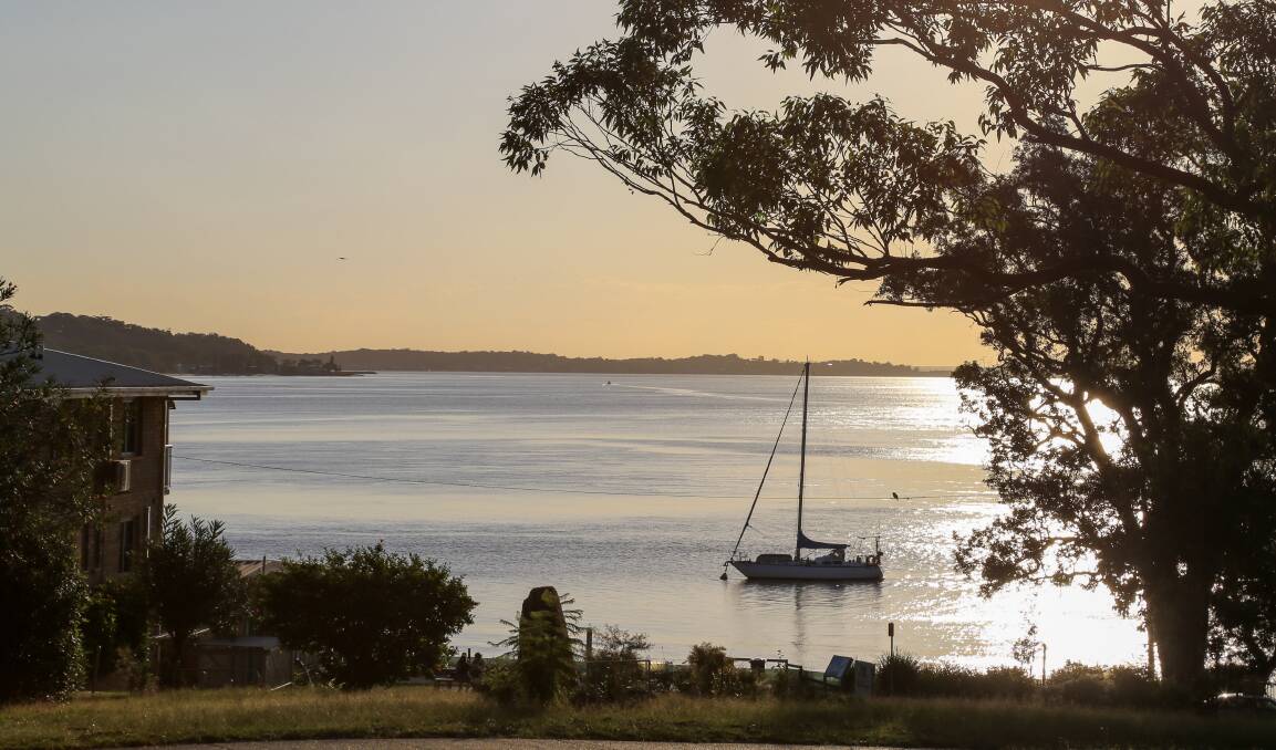 SERENITY: A yacht moored off Nelson Bay Beach at sunset after a warm, sunny day on Monday. Picture: Ellie-Marie Watts