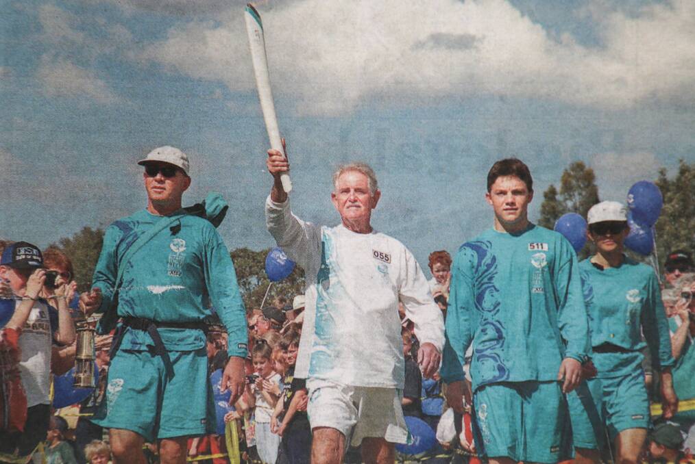 PROUD: Fingal Bay Olympian Hugh Lambie carried the torch into Raymond Terrace on August 27, 2000 as part of the Sydney Games' Olympic Torch Relay.