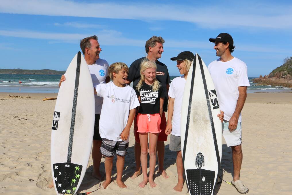SURF'S UP: Jimmi Hill, 10, Jessica Stretton, 11, and Isaac Sullivan , 13, with (back, from left) John Sullivan, Dave Stretton and Rod Astley at One Mile Beach. Picture: Ellie-Marie Watts