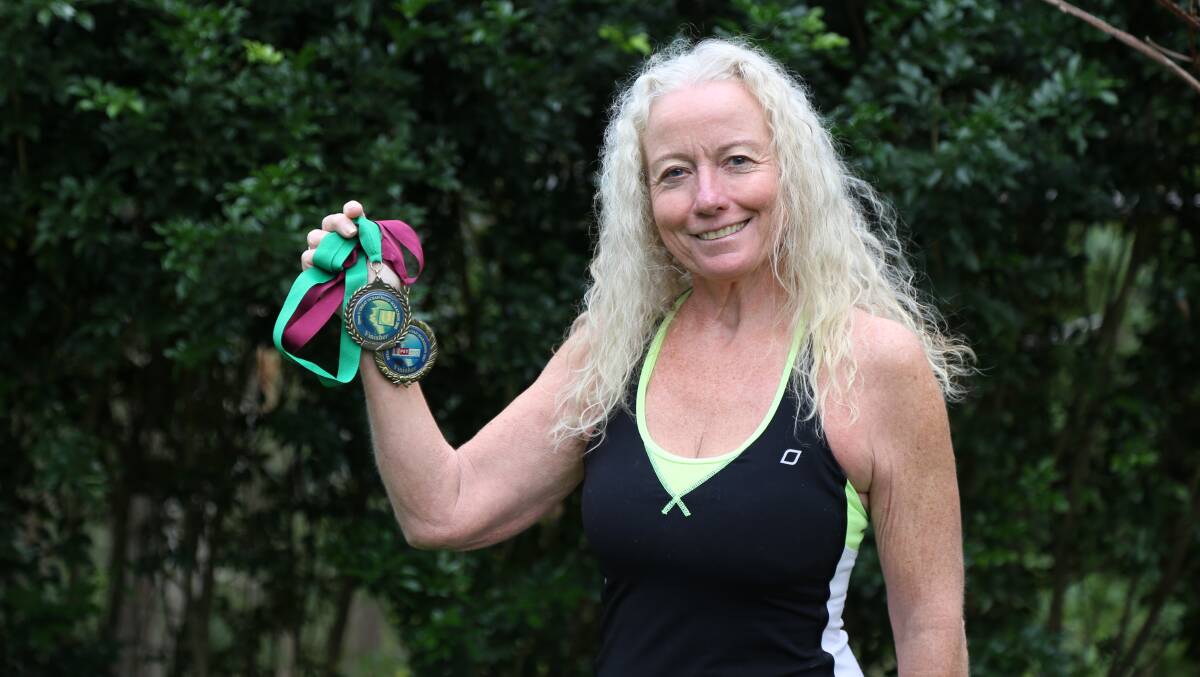 Anne Crawford-Nutte holding medals she received when she completed the Great Ocean Road Running Festival full marathon in 2007 and 2008. Picture: Ellie-Marie Watts