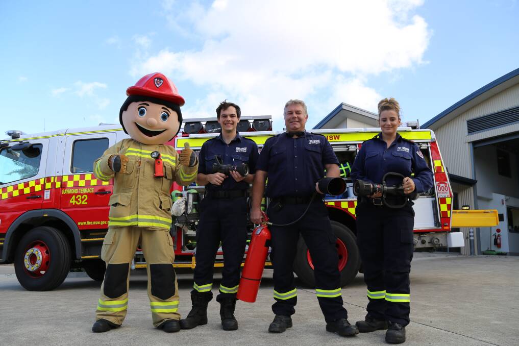 OPEN DAY: FRNSW mascot Bernie Cinders with Raymond Terrace firefighters Giacomo Arnott, James Blanch and Ebony Kennewell-Ingram. Pictures: Ellie-Marie Watts