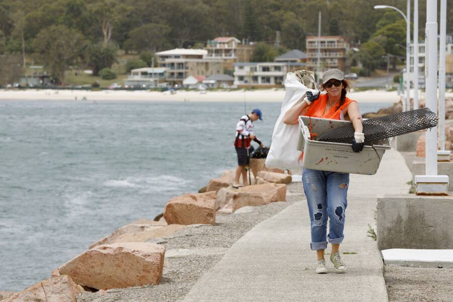 A Sea Shelters volunteer collecting rubbish from along the Nelson Bay breakwall. Picture: Florent Vidal Photography