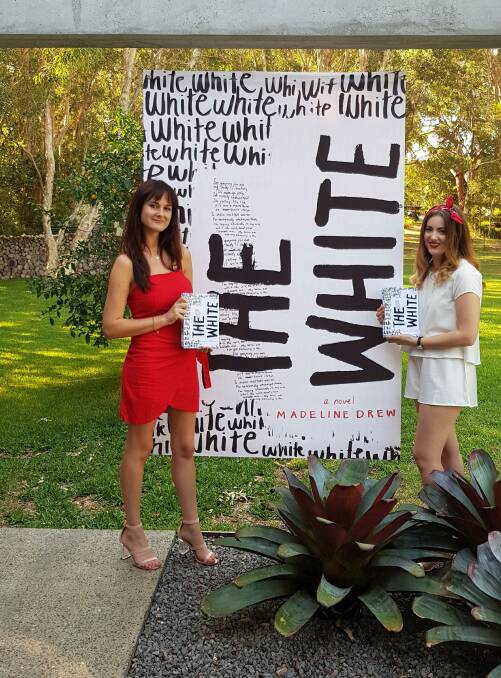 PARTNERS: Maddie Drew from Anna Bay, author of The White, with her friend Nicole Thompson, from Salamander Bay, who edited the book. 