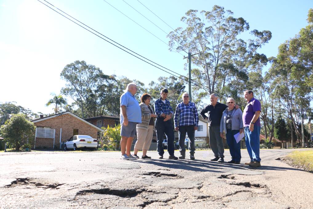 ROUGH GOING: Graham Brown, Dianne Brown, Kev Jansen, Les Hessell, Lyn Gaudion, Denise Gaudion and Rob Atkinson standing on Tanilba Road, Mallabula.