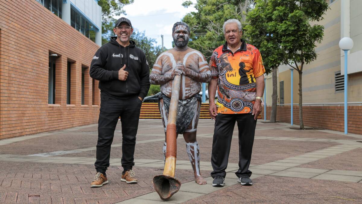ALWAYS WAS, ALWAYS WILL BE: Worimi Local Aboriginal Land Council CEO Andrew Smith, John Schultz with the didgeridoo and Worimi elder Uncle John Ridgeway OAM at the NAIDOC Week flag raising ceremony in Raymond Terrace on Monday. Picture: Ellie-Marie Watts
