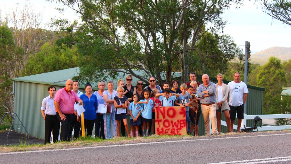 Port Stephens west ward councillors Ken Jordan, Paul Le Mottee and Giacomo Arnott standing with Seaham residents on the side of Warren Road, at the site where Optus has plans to install a mobile base station and tower. Photo: Supplied