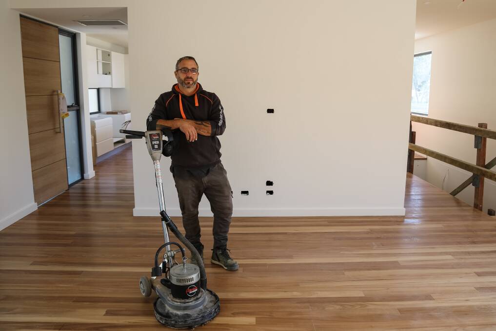 KEEPING BUSY: East Coast Timber Floors and More owner and Jim Robertson at a work site in Nelson Bay. Picture: Ellie-Marie Watts