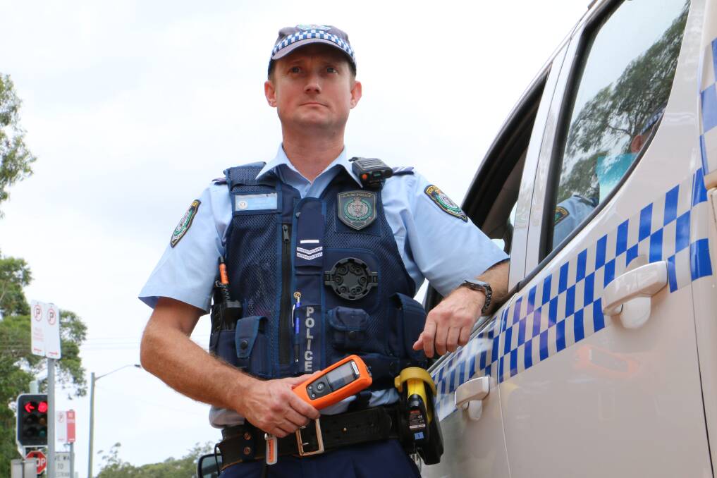 DRIVE SAFE: Port Stephens-Hunter Police District senior constable Duncan Arnold with a breathalyser. Alcohol was a factor in a number of Port's fatal crashes in 2018.