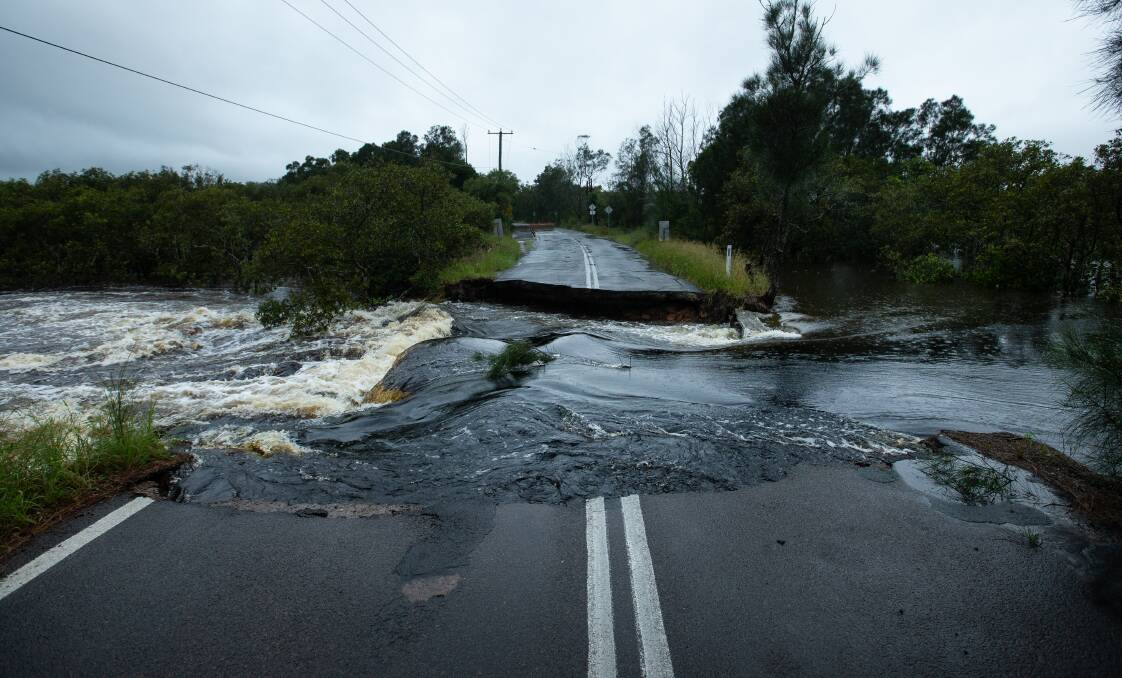 Pictures of the Foreshore Drive culvert collapse on Thursday, March 18. Pictures: Newcastle Herald/Marina Neil