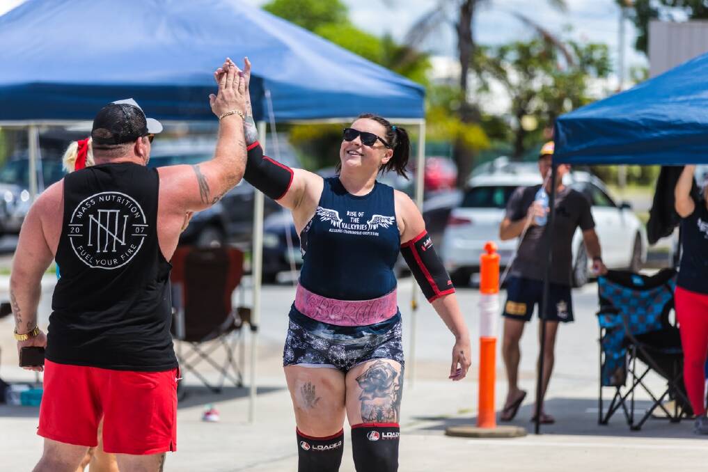 TEAM WORK: Benny Chessum high-fives partner Rebekah North during a strongman competition. Picture: Supplied