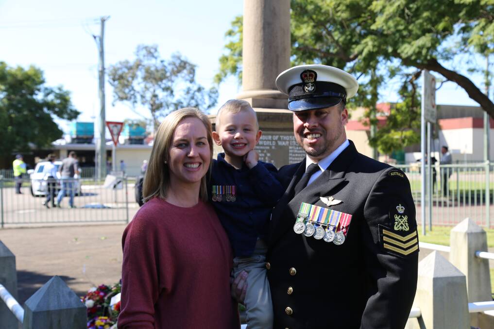 GIVE THANKS: Samantha Merrick, Blake Merrick, 3, and RAN Petty Officer Neale Merrick at the Raymond Terrace mid-morning Anzac Day service on Sunday. Picture: Ellie-Marie Watts