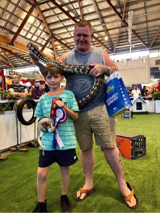 Flyn Andrews, 8, with Moo Moo and Adam Andrews with Bella after winning awards for their snakes at the Sydney Royal Easter Show. Picture: Supplied