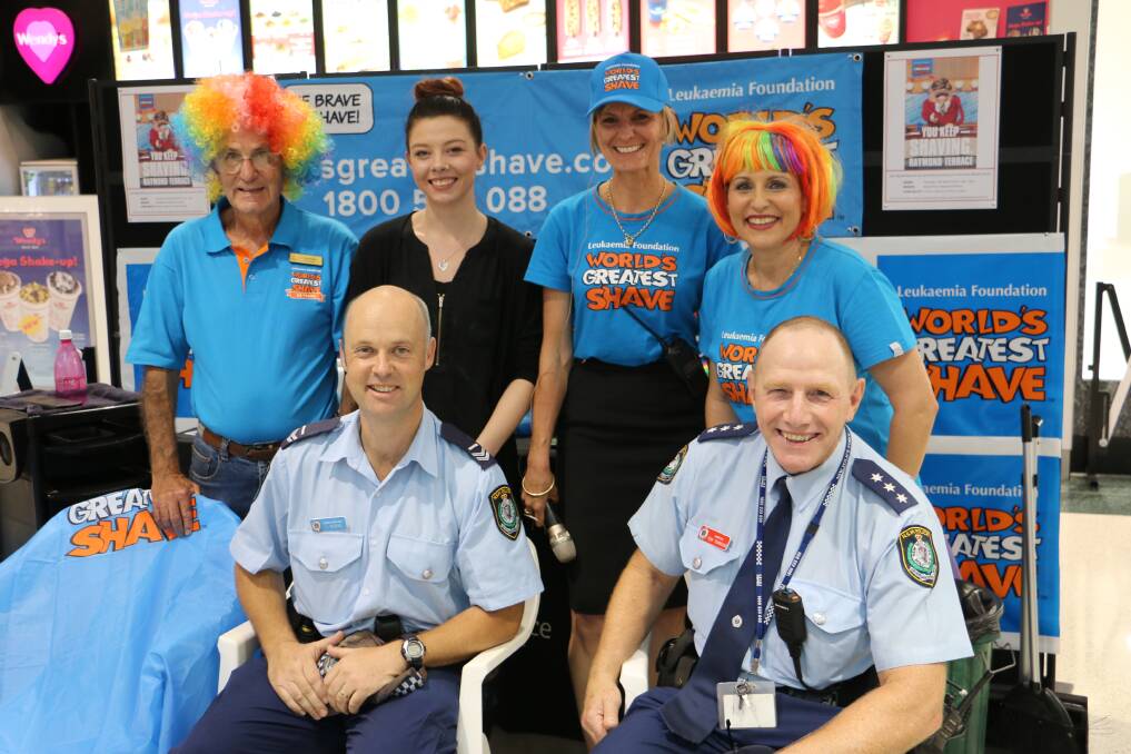 Leukaemia Foundation volunteer Lachlan McVicar with (back) Taylah Rickwood-Ager from Christiane's Hair Design, Colleen Mulholland-Ruiz and Michelle Sweeney qne (front) Senior Constable Luke Rogers and Chief Inspector Tony Townsend.