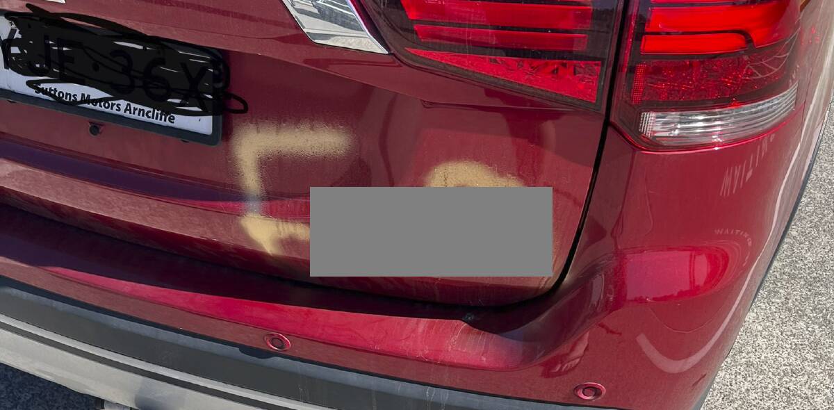 'UNACCEPTABLE': Vandalism on the rear of Chris Baguley's car. Homophobic slurs and a swastika was spray-painted on the rear driver's side and back.