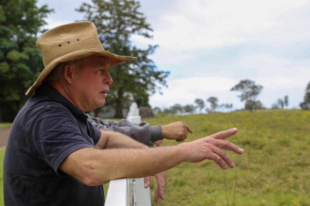 Nelsons Plains cattle farmer Peter Manuel speaking with neighbour Peter Bartolo as they look out to the land earmarked for development.