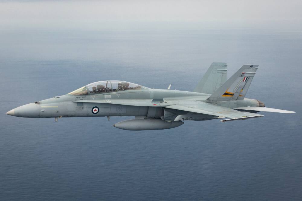 F/A-18 B Hornet A21-111 from Williamtown flies off the coast of Newcastle. Picture: FSGT Mick Bott
