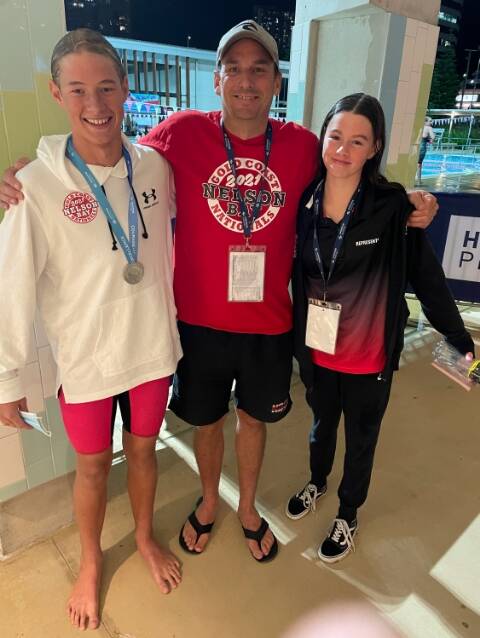 GOOD FORM: Nelson Bay Swim Club coach Tom Davis (centre) with Randall Ingram and Ebony Nix on the Gold Coast at the beginning of April where the teens won silver at the 2021 Australian Age Swimming Championships. Picture: Supplied