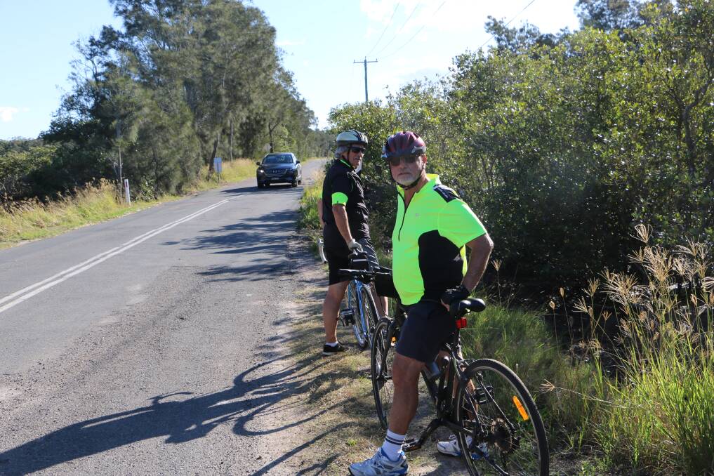 Cyclists on Foreshore Drive show how close they are to traffic near the Mambo culvert.
