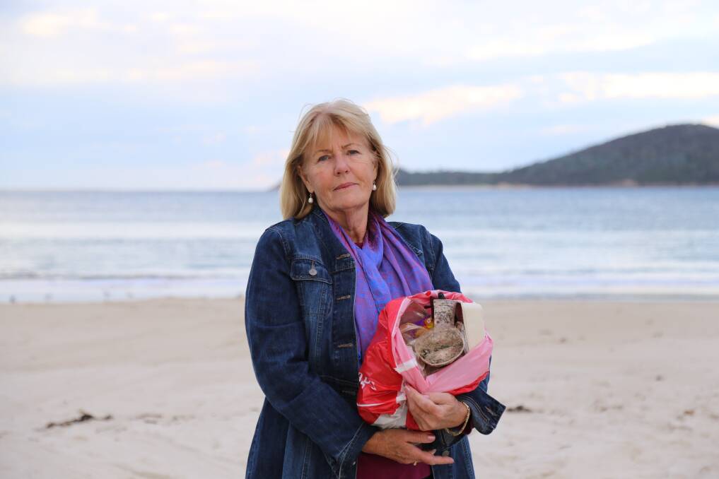 NO STEPPING BACK: Pamela Smith with rubbish collected from Fingal Beach on the first weekend in June one year after the YM Efficiency spill. Picture: Ellie-Marie Watts