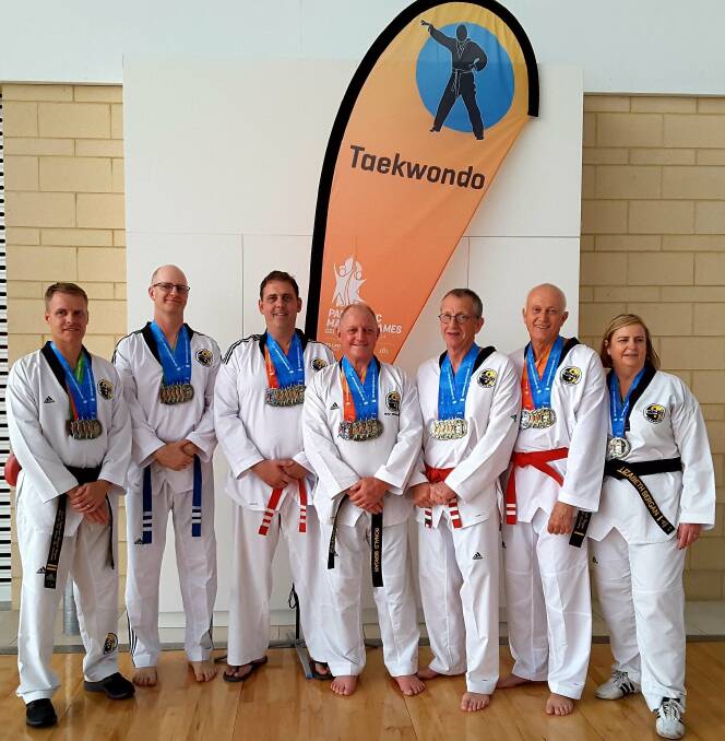 MEDALLISTS: Him Do Taekwondo members and master Ronald Bergan (centre) with their swag of Pan Pacific Masters Games medals. Ages in the team ranged from 44 to 66 years.