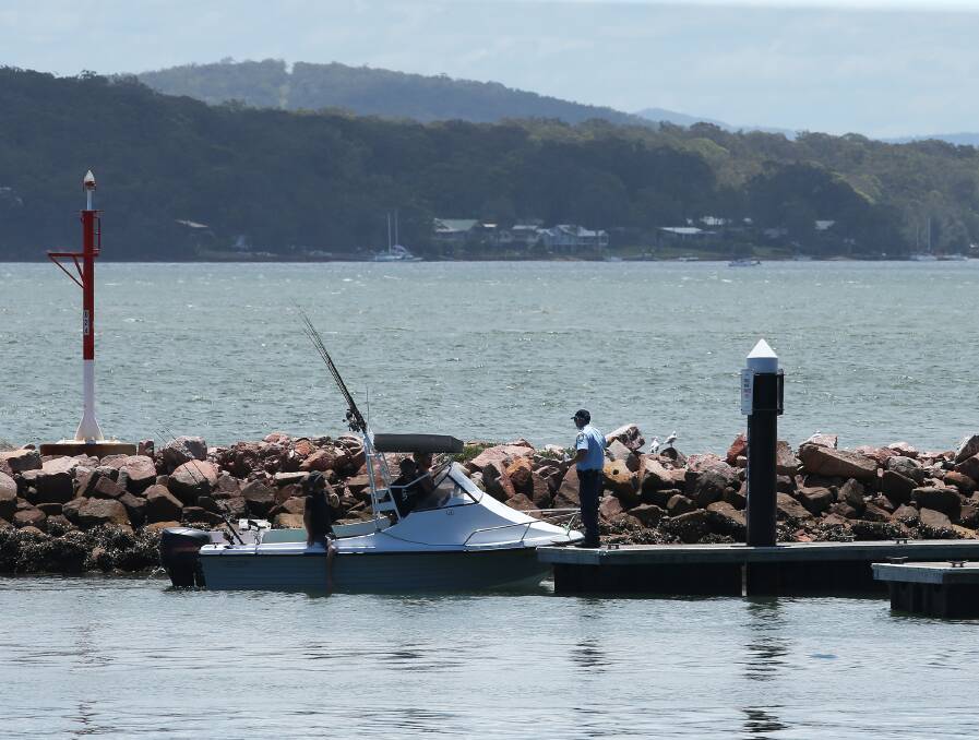 Police at Soldiers Point boat ramp on Sunday, January 2 after a car with two bodies inside was pulled out of the water. Picture: Peter Lorimer 