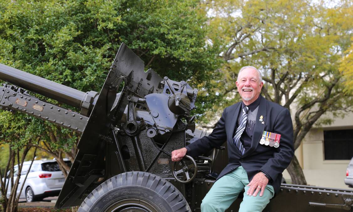 PIECE OF HISTORY: Raymond Terrace RSL Sub-Branch member Kerry Allen sits upon the town's restored 25-pound Mark II artillery gun used by Australian gunners like his father during World War II. Picture: Ellie-Marie Watts