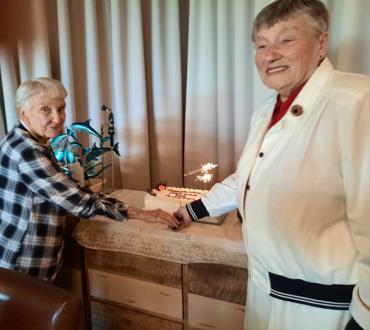 NICE: Lyn Fairless, the original secretary of the Fingal Haven Craft Group, Norma Shylan, an original member, cutting the cake at the April 27 celebration.