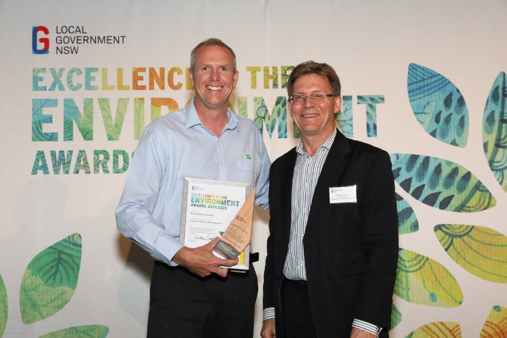 REWARD: Port Stephens Councils strategy and environment section manager, Steve Peart, accepting the award from Bruce Christie, deputy director-general of biosecurity and food safety at NSW Department of Primary Industries.