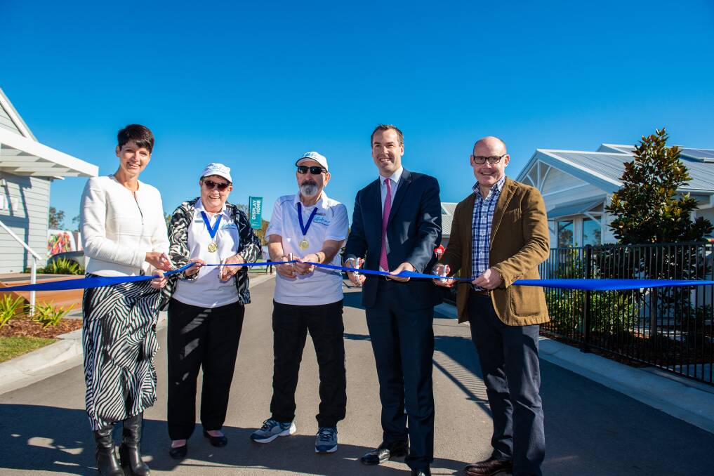 PROUD MOMENT: From left, Port Stephens MP Kate Washington, Latitude One residents Janette and Ken Scott, Port Stephens Mayor Ryan Palmer and Ingenia Lifestyle CEO Simon Owen cutting the ribbon to officially open the over-55 estate in Anna Bay on July 21. Picture: Supplied