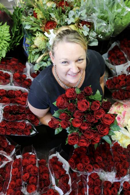 Deanne Elliott from The Gazebo Florist in Raymond Terrace with a delivery of red roses. Picture: Ellie-Marie Watts