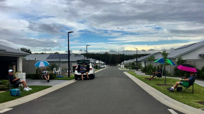 CREATIVE: Residents of Anna Bay's over-55s living estate Latitude One have turned their regular happy hour into "don't-mix-and-mingle" drinks at the end of their driveways.