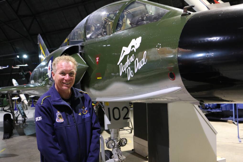 INSPIRATIONAL: Squadron Leader Danny Jeffery, an Invictus Games athlete, with "Daphne" at Fighter World in Williamtown on Wednesday. During his years with the RAAF he has worked on jets like Daphne. Picture: Ellie-Marie Watts