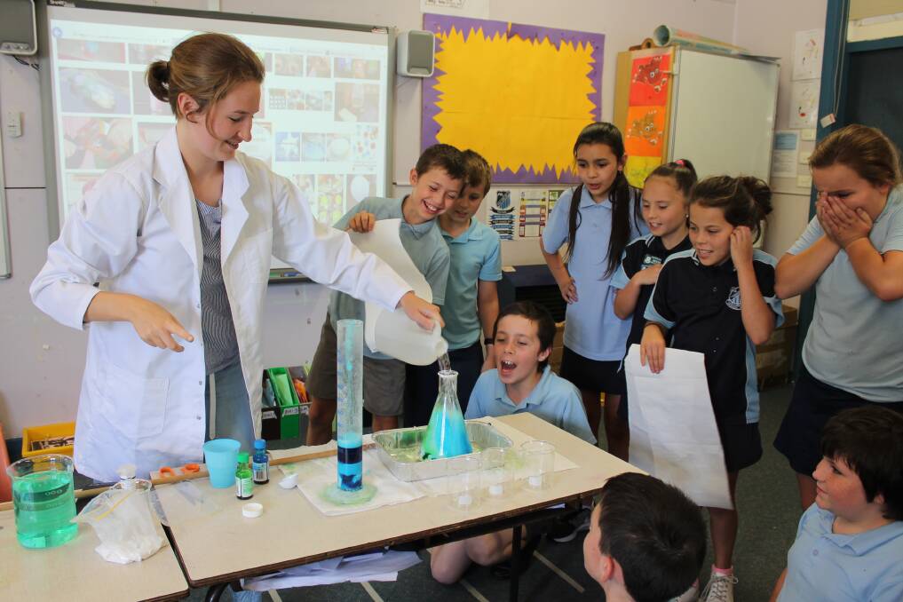BIG HIT: Natasha Egoroff, a research assistant at the University of Newcastle, doing an experiment with a Raymond Terrace Public School class. 