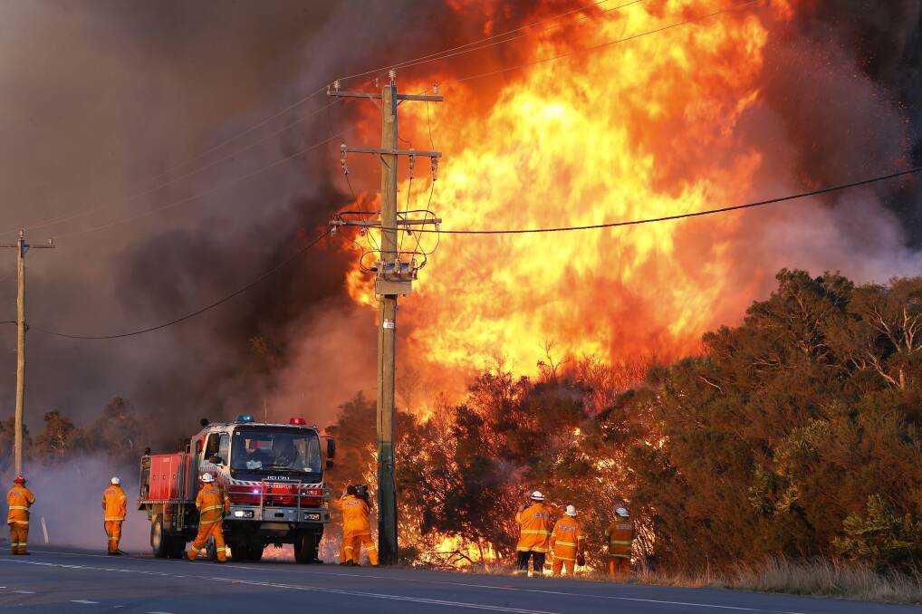 Back burning at Salt Ash on Sunday before it moved to emergency warning level. Picture: AAP Image/Darren Pateman