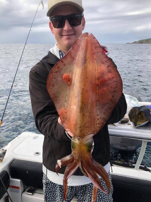 WHAT A CATCH: Sydney visitor Alex Shipley with a monster Broughton Island squid.