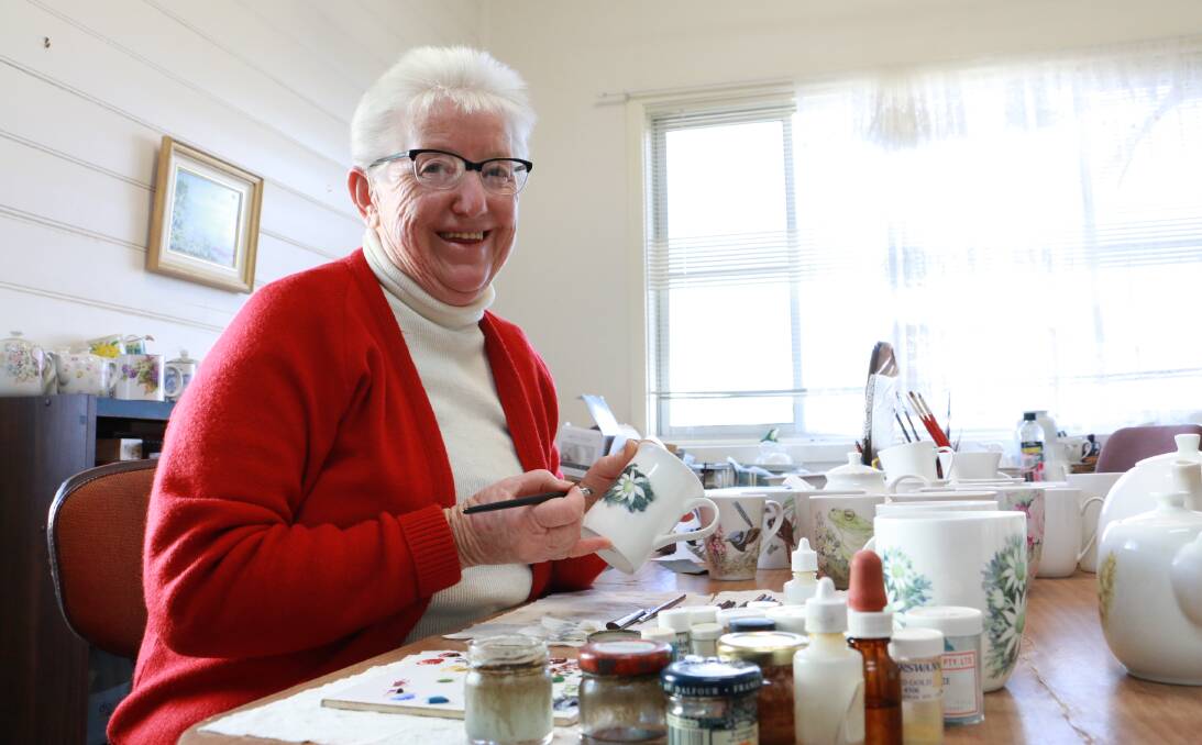 PATIENCE: Florence Humphreys at work painting porcelain at her home studio. Picture: Ellie-Marie Watts