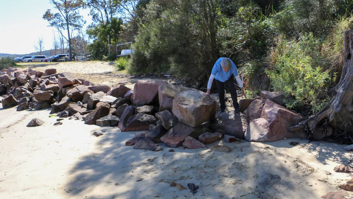 Jean Armstrong crossing the recently installed rock formation on Soldiers Point beach.
