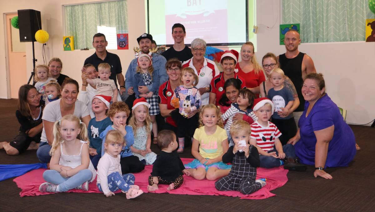 EXCITED: Baylife Church members and children with Pastor Greg McKewin (back left) are looking forward to Carols at the Bay, which will be held at Fly Point on December 9. Picture: Charlie Elias