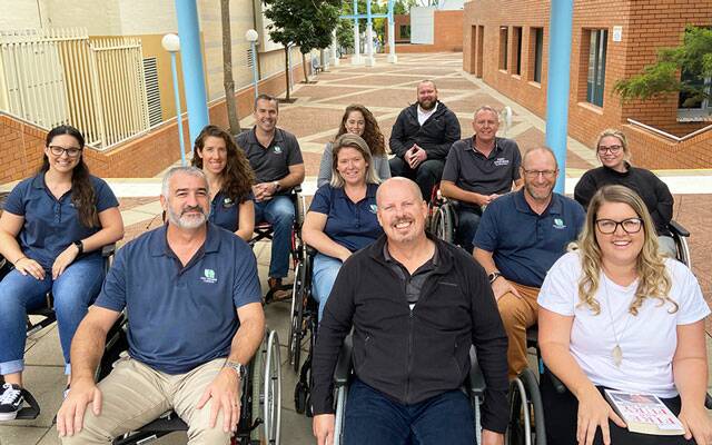 Port Stephens Council employees and mayor Ryan Palmer taking part in a wheelchair challenge to create more awareness about the challenges people face when completing everyday tasks.