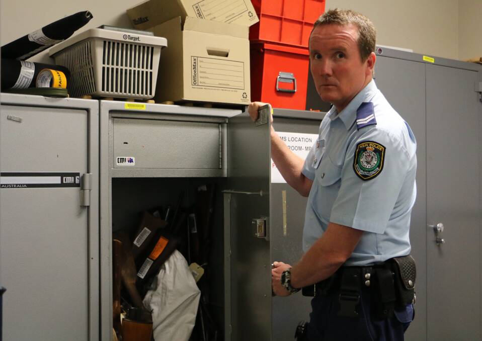 Senior Constable Marshall, pictured with the gun safes in Raymond Terrace Police Station. The senior constable and his wife, Sergeant Kristin Marshall, transferred from Young to the Port Stephens Local Area Command on Tuesday. Picture: Ellie-Marie Watts