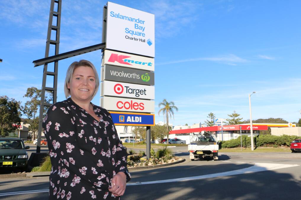 FRESH FEEL: Charter Hall marketing manager Abby Richards standing under a sign reflecting Salamander Bay shopping centre's name change to Salamander Bay Square. Picture: Ellie-Marie Watts
