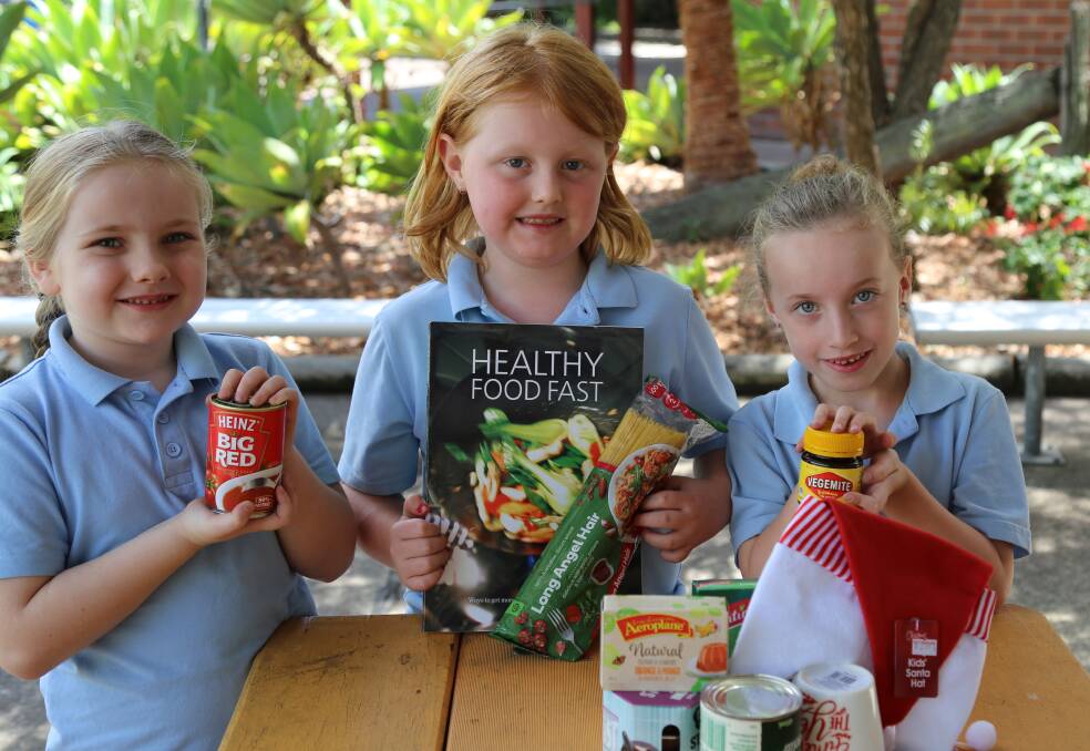 Raymond Terrace Public School students Evie Smith, 6, Rhiannon Clynes, 7, and Maddie Barnes, 6, from class 1ND. Picture: Ellie-Marie Watts