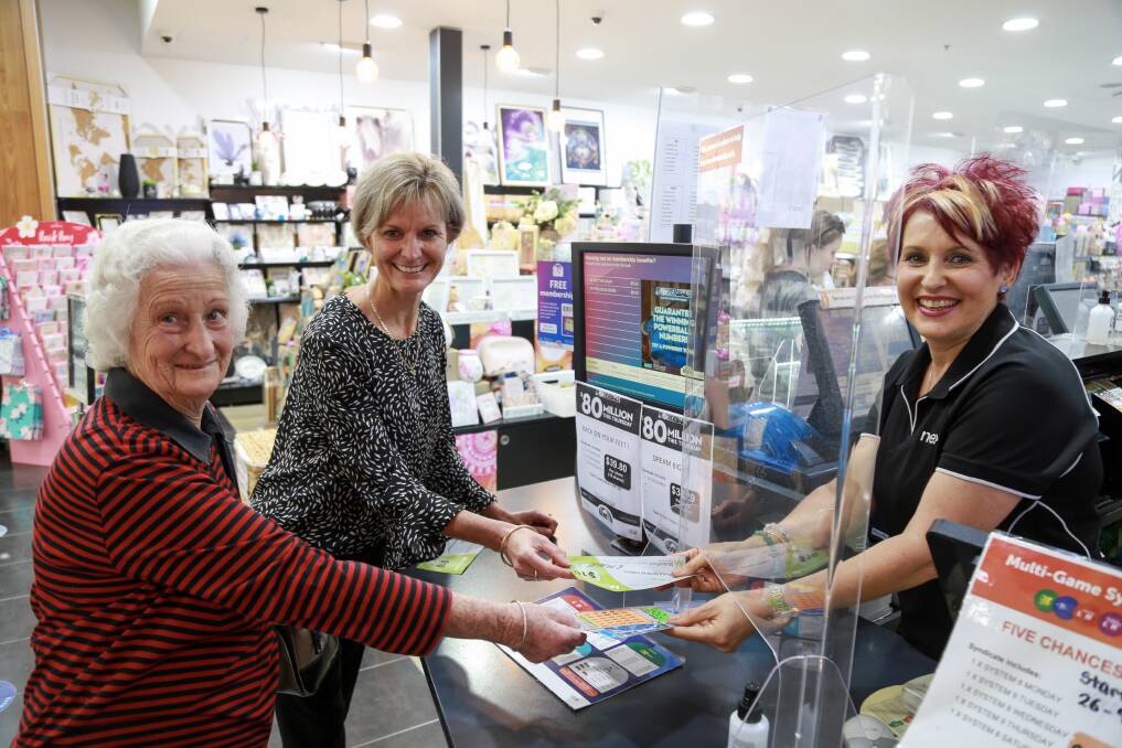 WHAT GOES AROUND: MarketPlace Raymond Terrace centre manager Colleen Mulholland-Ruiz buying a lotto ticket from newsagent Michelle Sweeney for a customer as part of the Pay It Forward campaign.