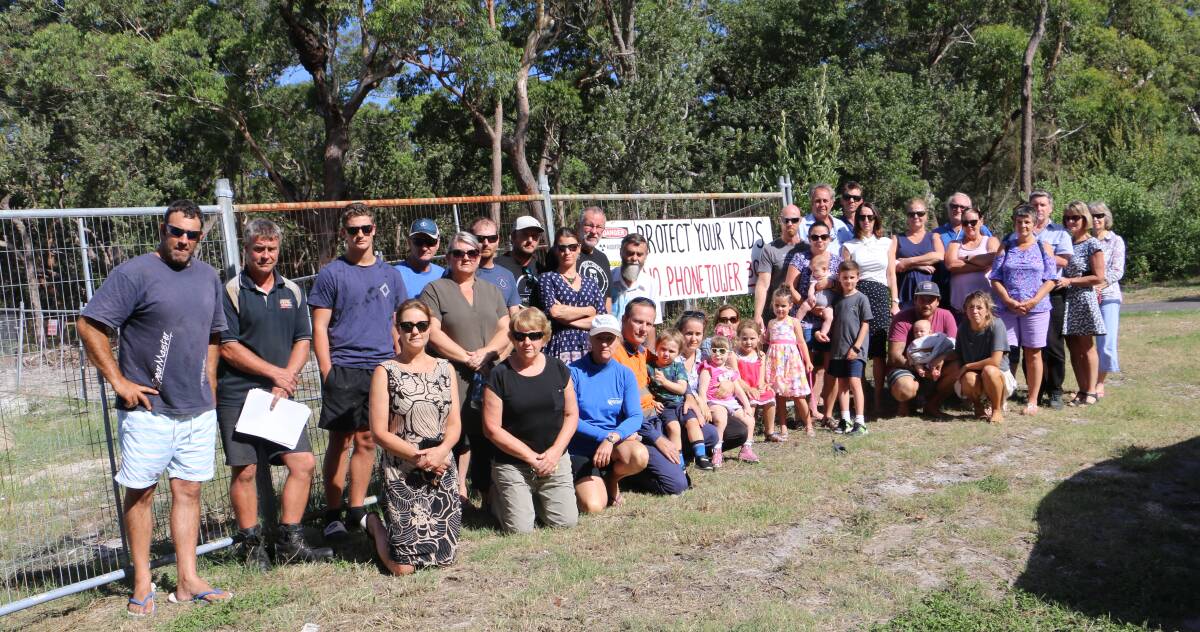  Around 40 residents protested against the proposal to site the Optus mobile phone tower at the top of Anna Bay's Clark Street on Monday.