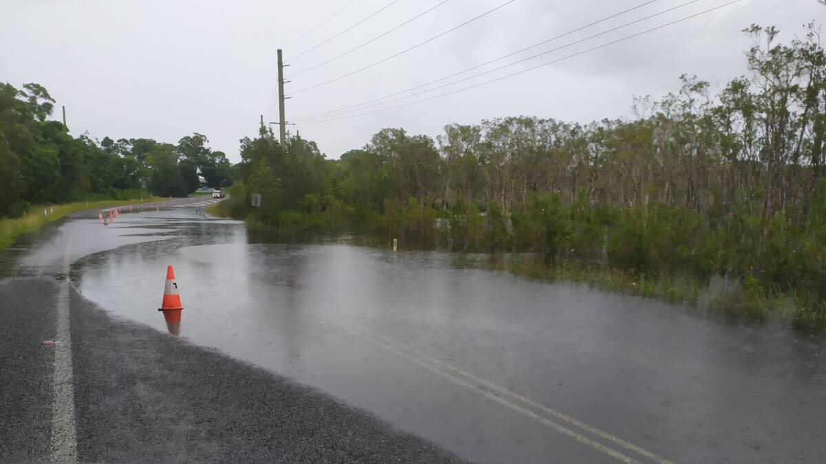 Water over Nelson Bay Road - in between Frost Road and Salamander Way - on Monday, March 22. The water remains over the road and is impacting traffic in and out of the Bay. Picture: Gary Duckett