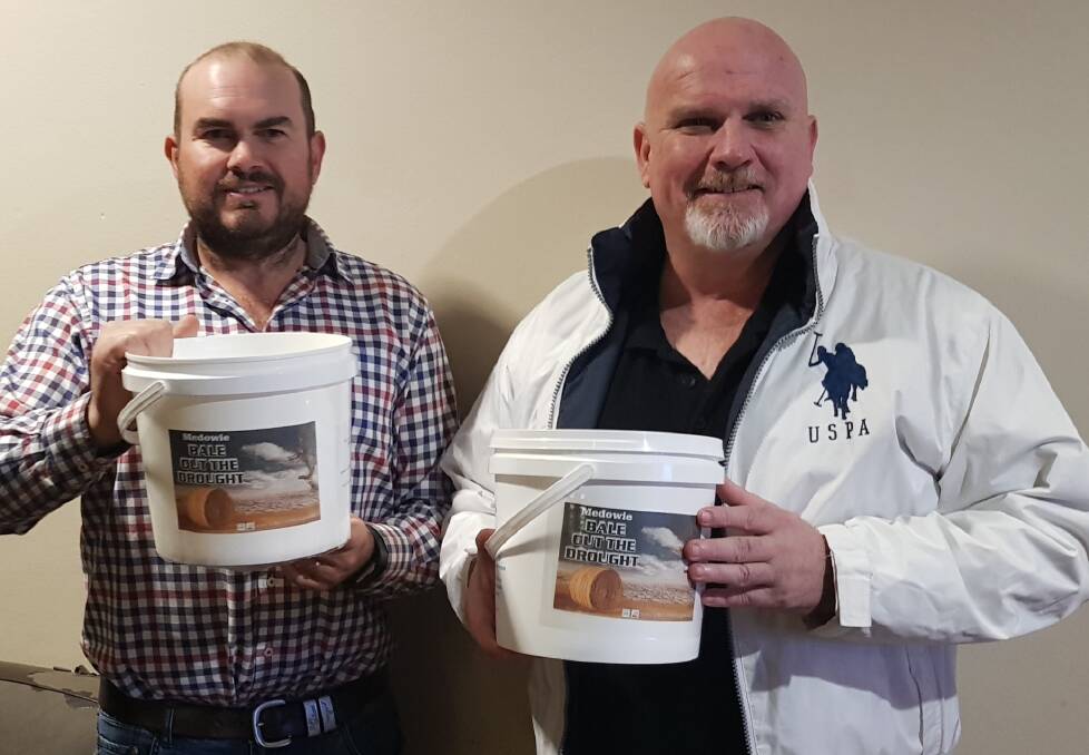 Ben Niland and Port Stephens councillor Chris Doohan with the campaign buckets that will be passed around Medowie to raise funds for Rural Aid's drought relief.