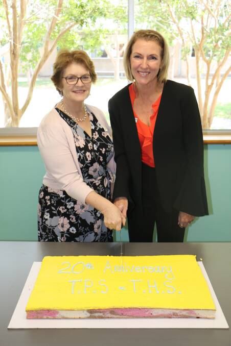 Tomaree High School principal Sue Xenos and Tomaree Public School principal Christene King cutting the 20th anniversary cake.