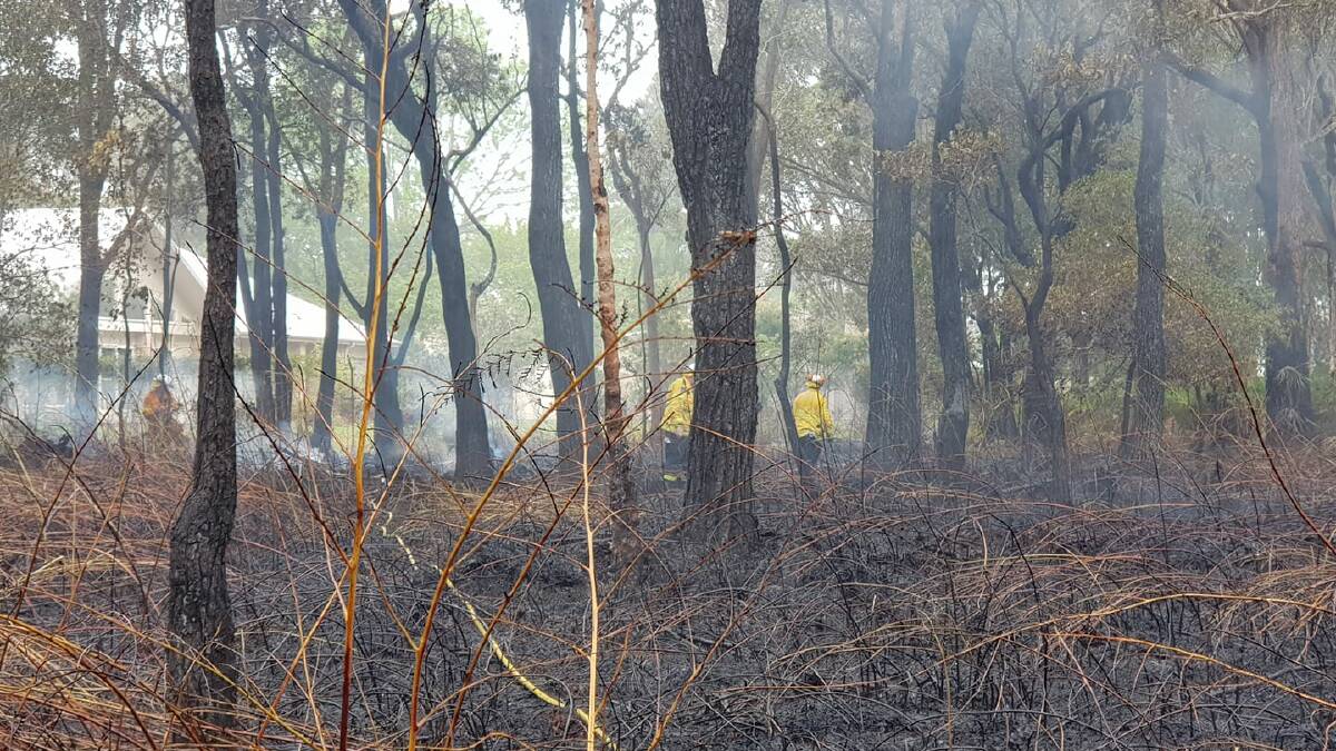 CONTAINED: Rural Fire Service members on the fire ground in Tanilba Bay on Saturday morning. Picture: Facebook/Tilligerry Rural Fire Brigade